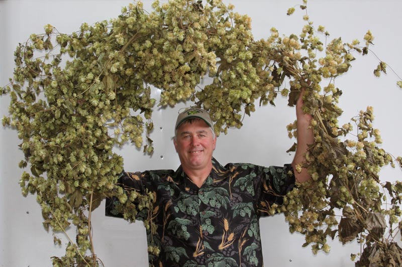 Dave holding vine of hops